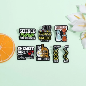 Creative science enamel pins set featuring DNA, microscope, and lab tubes on green background