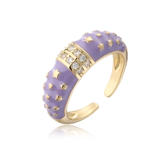 Macro shot of purple enamel star ring with gold plating and glittering zircon stones