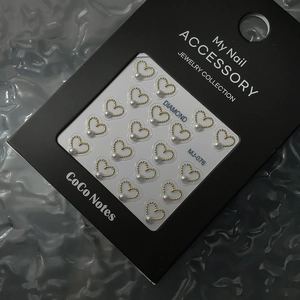 Golden hollow heart nail charms with white pearls for creative manicure design