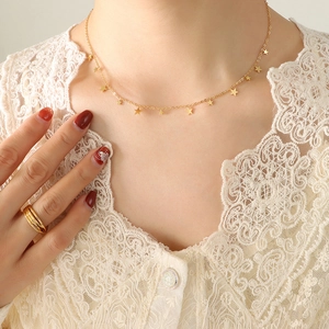 Elegant 18K gold plated star pendant necklace and layered ring set on female model