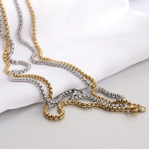Detail of 12mm square dice pendant necklaces with gold and silver box chains