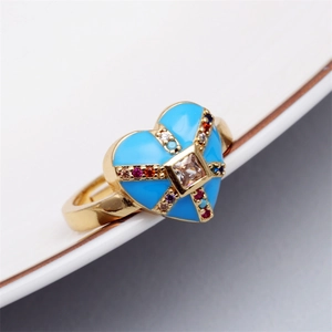 Detailed close-up of heart enamel evil eye ring with colorful micro-inlaid zircons