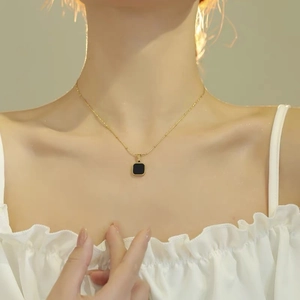 Titanium steel gold-plated necklace with a black square pendant worn by a model