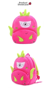 Detail of plush pitaya fruit backpack with cute cartoon face and soft 3D green leaves