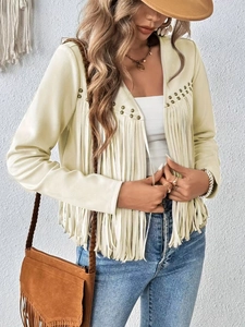 Detailed close-up of beige suede fringe jacket with metal stud accents and fluid tassels