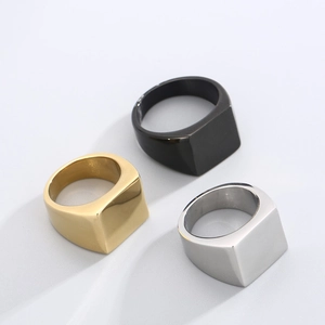 Detailed view of square signet rings in polished gold, silver and matte black steel
