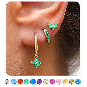 Detailed view of gold cartilage earrings set with green stones and 12 birthstone options