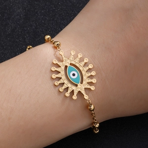 Gold stainless steel evil eye bead bracelet for women featuring blue enamel charms