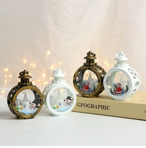 Detail of gold and white Christmas LED lanterns with Santa and snowman scenes inside