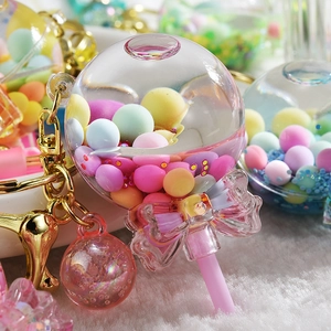 Close-up of lollipop acrylic shaker keychain with colorful beads and sequins inside