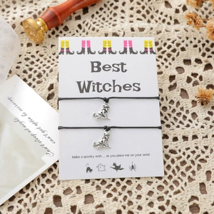 Detail of Best Witches charm bracelets with silver witch pendants on Halloween gift card