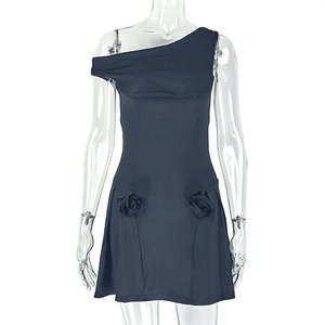 Detail of 3D fabric roses and pleated waist on a black one-shoulder mini dress