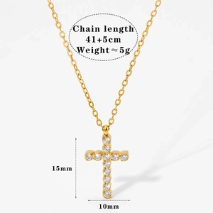 Detail view of gold cross pendant with 11 zircon stones and adjustable chain dimensions