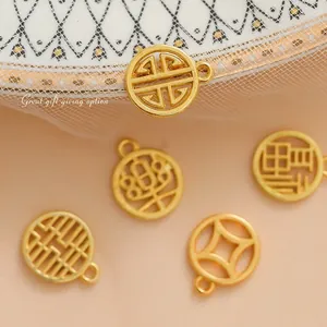 Set of five gold hollow metal Chinese wedding favor pendants with traditional patterns