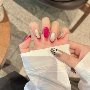Long almond-shaped rose red and champagne gold glitter press-on nails with leopard patterns