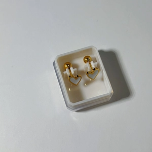 Top view of gold heart stud earrings with white inlay and screw-back ball closure
