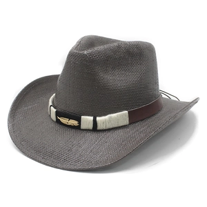 Gray western straw cowboy hat with a wide brim and decorative feather band accessory