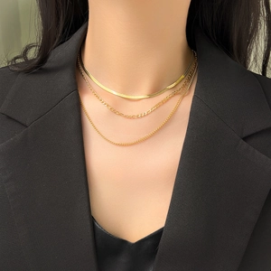 Three-layer 18K gold plated snake and Figaro chain necklace set on model wearing black suit