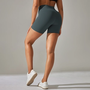 Rear view of high waisted dark green yoga shorts showing body contouring and lifting fit
