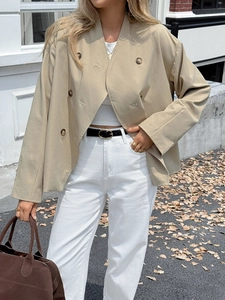 Detailed close-up of khaki double-breasted cotton blend blazer on a fashion model