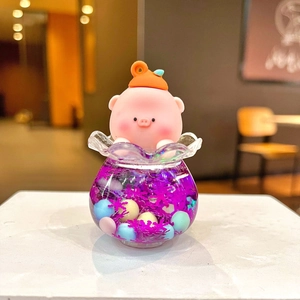 Detail of pink pig figurine on a purple liquid glitter base for bag charms and decor
