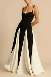Detail view of contrast black strap top and white pleated skirt on a summer dress