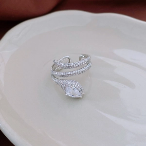 Detail of silver snake ring with sparkling zircon stones and water-drop shaped main crystal