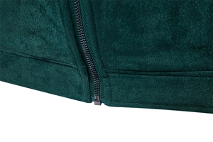 Close-up of the dark green suede jacket hem showing the durable metal zipper detail