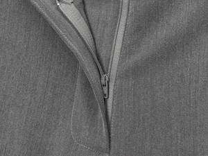 Close-up of a durable metal zipper and stitching on gray long casual shorts for women