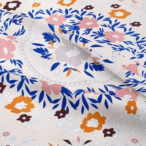 Close-up of floral tapestry fabric texture with blue leaves and colorful flower print