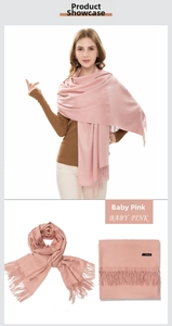 Detail of baby pink cashmere scarf showing soft texture and long fringe tassels