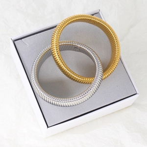 Dual-tone gold and silver tubogas snake-pattern stretch bracelets in a gift box