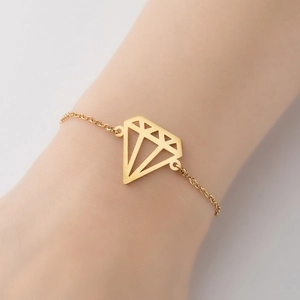 Minimalist gold chain bracelet with geometric hollow diamond charm on a woman wrist