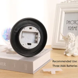 Preserved gold foil rose in glass dome with LED light base showing the battery compartment