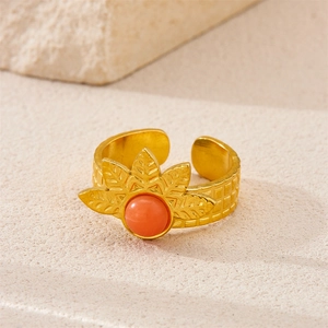 Close-up of 18k gold vintage ring with orange-red gemstone and leaf detail