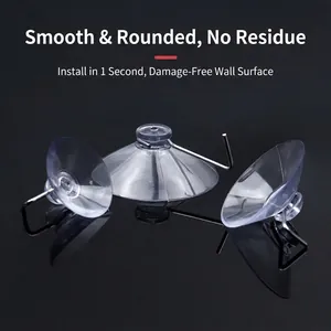 Set of 3 transparent vacuum suction cup hooks with metal hangers on reflective surface