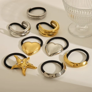 Close-up of elegant gold and silver elastic hair ties with star and moon metal charms