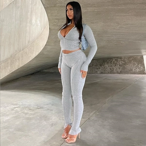 Close-up of gray waffle knit texture on slim fit zip-up sports jacket and leggings set