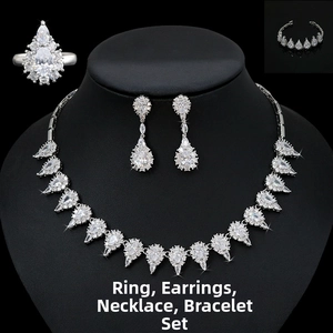 Close-up of bridal jewelry set with pear-cut crystals on necklace, earrings and bracelet