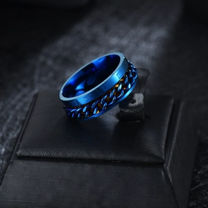 Detail of blue spinner ring with rotatable chain and engraved Roman numerals on band