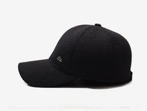 Detail view of the black winter baseball cap showing textured fabric and side metal logo
