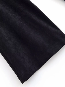 Detailed close-up of high-quality black velvet fabric texture and fine stitching on pants