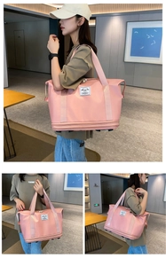 Detail of pink waterproof travel bag with double handles and bottom expansion zipper feature