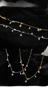Detail of S925 sterling silver chains with freshwater pearls and sparkling zircon charms