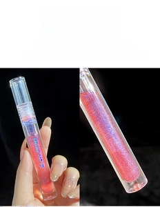 Macro shot of Pudding Orange shimmer lip gloss with glossy mirror finish and glitter