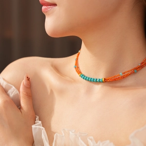 Detail showing vintage multi-layer beaded necklace with orange and turquoise stones