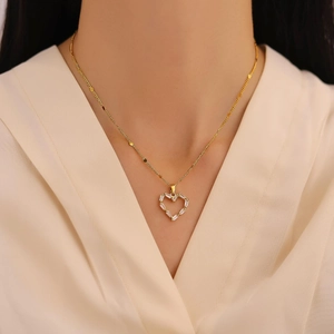 Elegant gold heart pendant necklace with clear zircon stones on a beaded chain for women