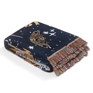 Detail of bohemian star and planet woven blanket with colorful decorative tassels