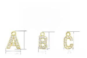 Detailed view of micro-pave gold alphabet charms A, B, C with 11.4mm height dimensions