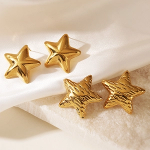 Minimalist 18K gold plated stainless steel star stud earrings on white silk and stone